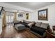 Spacious living room with a large sectional sofa and wood-look floors at 3303 Brigadoon Dr, Clearwater, FL 33759