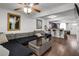 Open living area with L-shaped sectional sofa and view of kitchen at 3303 Brigadoon Dr, Clearwater, FL 33759