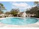 Community pool with surrounding lounge chairs and landscaping at 3303 Brigadoon Dr, Clearwater, FL 33759