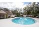 Community pool with surrounding lounge chairs and landscaping at 3303 Brigadoon Dr, Clearwater, FL 33759