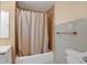 Bathroom with shower/tub combo and beige tile at 3916 W Oklahoma Ave, Tampa, FL 33616