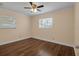 Spacious bedroom with hardwood floors and ceiling fan at 3916 W Oklahoma Ave, Tampa, FL 33616