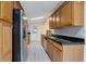 Modern kitchen featuring stainless steel appliances and wood cabinets at 3916 W Oklahoma Ave, Tampa, FL 33616
