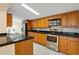 Kitchen with wood cabinets and stainless steel appliances at 3916 W Oklahoma Ave, Tampa, FL 33616