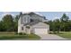 Two-story craftsman style home with gray siding, stone accents, and a two-car garage at 3949 Northern Key Dr, Plant City, FL 33563