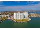 Aerial view of waterfront condo building with boat slips and city views at 400 64Th Ave # 508, St Pete Beach, FL 33706