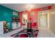 Small dining area with red chairs and a white round table at 400 64Th Ave # 508, St Pete Beach, FL 33706