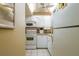 Efficient kitchen with white cabinets, appliances, and a corner sink at 400 64Th Ave # 508, St Pete Beach, FL 33706