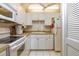 White kitchen with ample cabinetry and modern appliances at 400 64Th Ave # 508, St Pete Beach, FL 33706