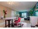 Bright living room with teal accent wall, comfy seating, and ocean view at 400 64Th Ave # 508, St Pete Beach, FL 33706