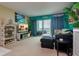 Living room with teal walls, comfortable seating and ocean views at 400 64Th Ave # 508, St Pete Beach, FL 33706