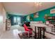 Bright living room with teal accent wall, comfy seating, and ocean view at 400 64Th Ave # 508, St Pete Beach, FL 33706