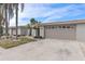 Tan colored house with attached garage and landscaping at 407 Boca Ciega Point N Blvd, St Petersburg, FL 33708
