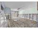 Living room with damaged flooring and exposed framing at 407 Boca Ciega Point N Blvd, St Petersburg, FL 33708