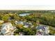 Aerial view of waterfront home with a large backyard and surrounding houses at 608 Florida Blvd, Crystal Beach, FL 34681
