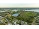 Aerial view showing a neighborhood near a lake at 608 Florida Blvd, Crystal Beach, FL 34681