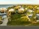 An aerial view of vacant lot with neighboring houses and waterfront access at 608 Florida Blvd, Crystal Beach, FL 34681