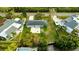 House with backyard patio, and surrounding neighborhood, from above at 608 Florida Blvd, Crystal Beach, FL 34681