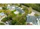 High-angle view of home with backyard patio, boat, and surrounding area at 608 Florida Blvd, Crystal Beach, FL 34681