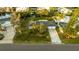 An aerial view of a single Gathering home with a large yard and driveway at 608 Florida Blvd, Crystal Beach, FL 34681
