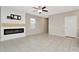 Spacious living room featuring a modern fireplace and tile floors at 6180 Apple Snail Ave, New Port Richey, FL 34653