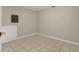 Image shows a basement space with tiled floor and access door to utility panel at 6210 92Nd N Pl # 3405, Pinellas Park, FL 33782