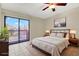 Well-lit bedroom featuring a sliding glass door, ceiling fan, and neutral decor, offering comfort and style at 6210 92Nd N Pl # 3405, Pinellas Park, FL 33782