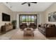 Living room featuring leather furniture, a TV, and a sliding glass door to the porch at 6210 92Nd N Pl # 3405, Pinellas Park, FL 33782