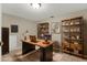 Office with wooden desk, shelves, laptop and a rug on tile floors at 6210 92Nd N Pl # 3405, Pinellas Park, FL 33782