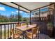 Screened porch with rustic wooden table and chairs, ideal for outdoor relaxation at 6210 92Nd N Pl # 3405, Pinellas Park, FL 33782