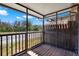 View from a screened porch with wooden floors and railings overlooking a scenic landscape at 6210 92Nd N Pl # 3405, Pinellas Park, FL 33782