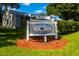 Community sign surrounded by lush greenery, and mulch, enhancing the neighborhood's appeal at 6210 92Nd N Pl # 3405, Pinellas Park, FL 33782