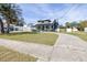 Gray house with a porch, driveway, and landscaping at 6303 Interbay Blvd, Tampa, FL 33611