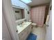 Bathroom with tub, shower, vanity, and light-colored tile floors at 7050 Sunset S Dr # 208, South Pasadena, FL 33707