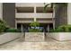 Building entrance with landscaping and Chateau Tower signage at 7050 Sunset S Dr # 208, South Pasadena, FL 33707
