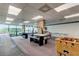 Game room with air hockey, foosball, and pool table at 7050 Sunset S Dr # 208, South Pasadena, FL 33707