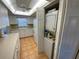 Bright kitchen with white cabinets, tile floors, and built-in appliances at 7050 Sunset S Dr # 208, South Pasadena, FL 33707