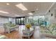 Bright community lobby with wicker seating and outdoor access at 7050 Sunset S Dr # 208, South Pasadena, FL 33707
