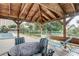 Relaxing gazebo with table and chairs near the pool at 7050 Sunset S Dr # 208, South Pasadena, FL 33707
