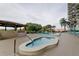 Community pool and spa area with relaxing seating at 7050 Sunset S Dr # 208, South Pasadena, FL 33707