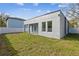 Large backyard with grassy area and privacy fence at 7711 N Orleans Ave, Tampa, FL 33604