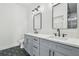 Modern bathroom with gray vanity, quartz countertop, and black fixtures at 7711 N Orleans Ave, Tampa, FL 33604