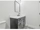 Stylish bathroom with a dark vanity and white marble countertop at 7711 N Orleans Ave, Tampa, FL 33604