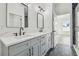 Modern bathroom boasts double sinks, quartz countertops, and black matte fixtures at 7711 N Orleans Ave, Tampa, FL 33604