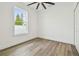 Bright bedroom with hardwood floors and a ceiling fan at 7711 N Orleans Ave, Tampa, FL 33604