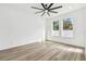 Spacious bedroom with ceiling fan and hardwood floors at 7711 N Orleans Ave, Tampa, FL 33604