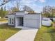 Modern home with gray exterior and attached garage at 7711 N Orleans Ave, Tampa, FL 33604