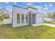 Modern house with gray exterior, stone accents, and attached garage at 7711 N Orleans Ave, Tampa, FL 33604