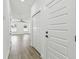 Bright hallway with hardwood floors and white doors leading to bedrooms at 7711 N Orleans Ave, Tampa, FL 33604