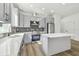 Modern kitchen with gray cabinets, quartz countertops, and stainless steel appliances at 7711 N Orleans Ave, Tampa, FL 33604